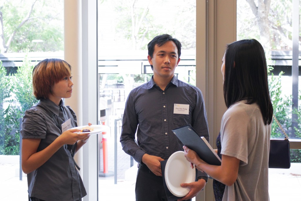 Scholarship recipient Eric Tang speaks with other attendees of the event. 