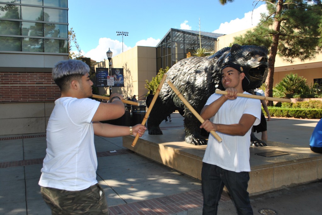 Pictured from left to right: Enrico Cortez practicing a choreographed fight scene with his partner, Michael Estabillo.